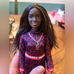 Black Barbie in sweat suit with music notes